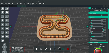 A 3D digital render of a winding, snake-like track or path on a beige base, shown inside a dark software interface with a Properties panel on the right. The render has green and orange highlights, and the surrounding UI includes tool icons and a grid workspace.
